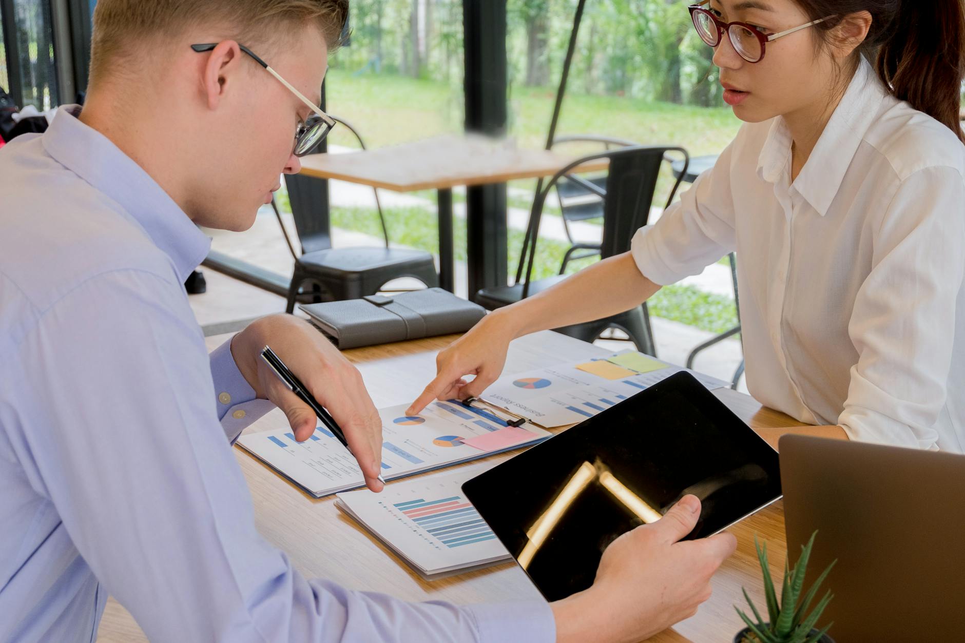 Business team planning technology strategy around a conference table with digital devices