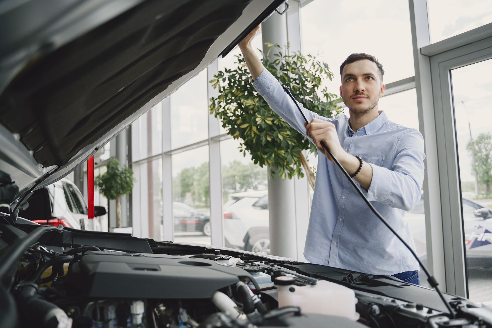 Modern automotive dealership showroom with digital displays and technology